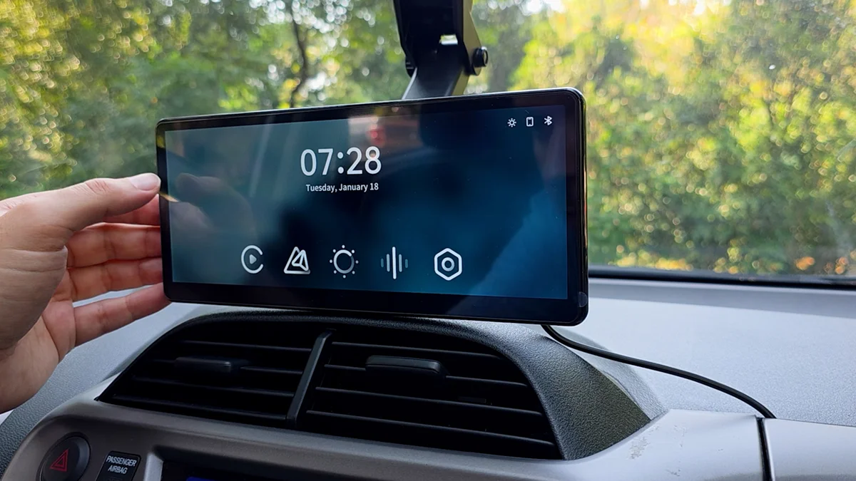 The CarpodGo T4 powered on, showing its home screen with CarPlay and Android Auto icons