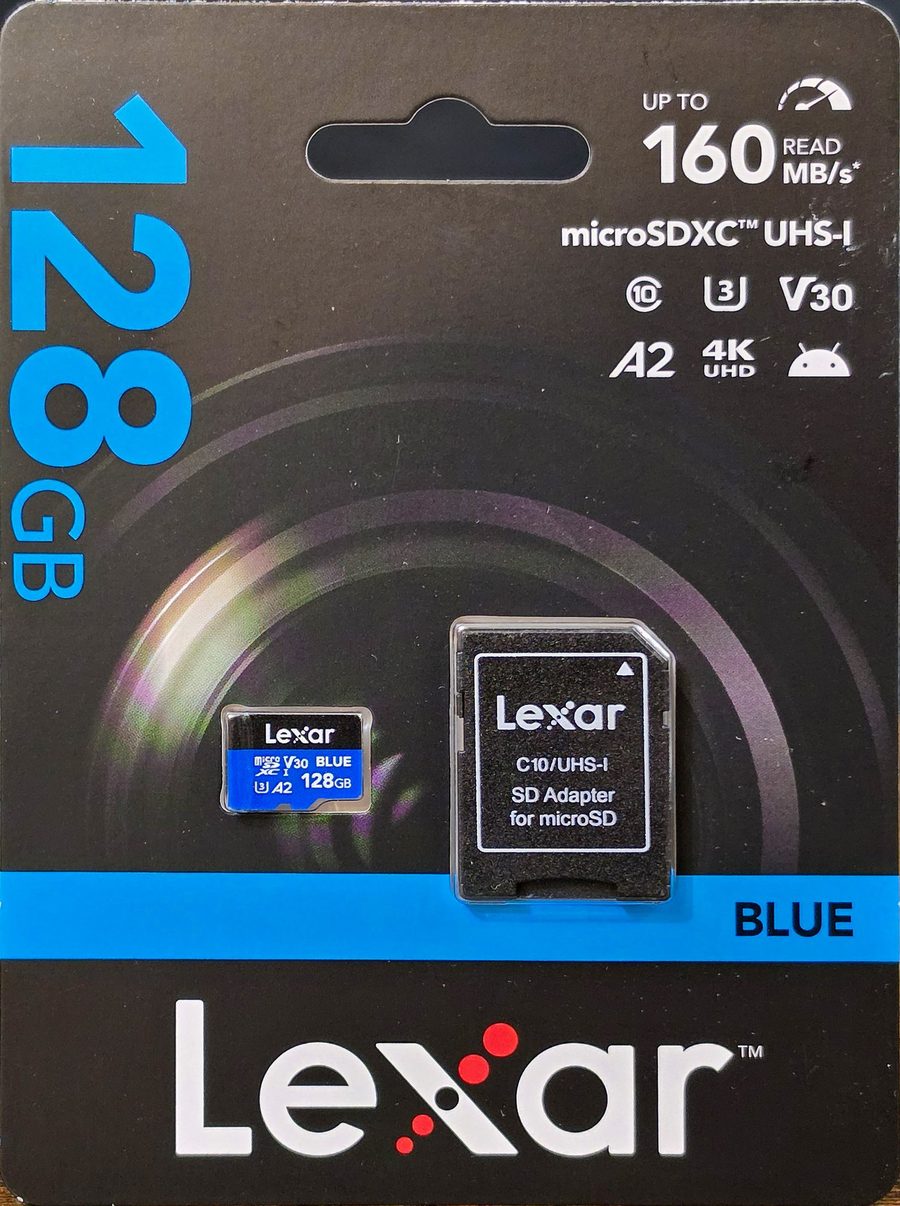 Lexar Blue 128GB microSDXC card in its retail blister packaging with the bundled SD adapter