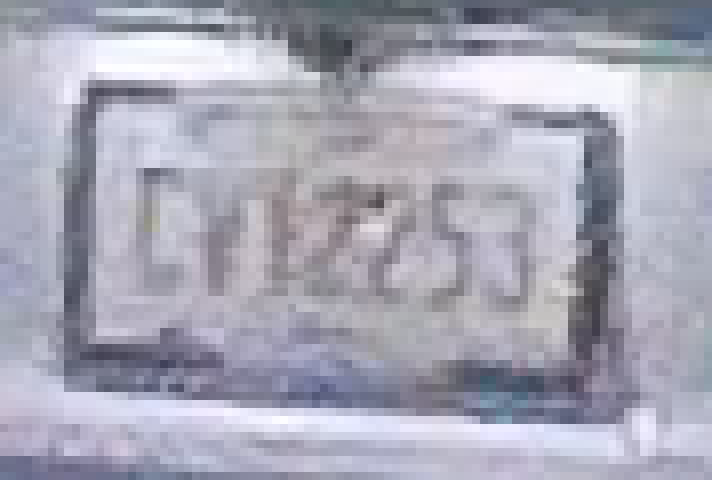 The same Jeep's plate at eight times enlargement with HDR on, a little farther away: a grey plate with a dark frame and all seven characters readable